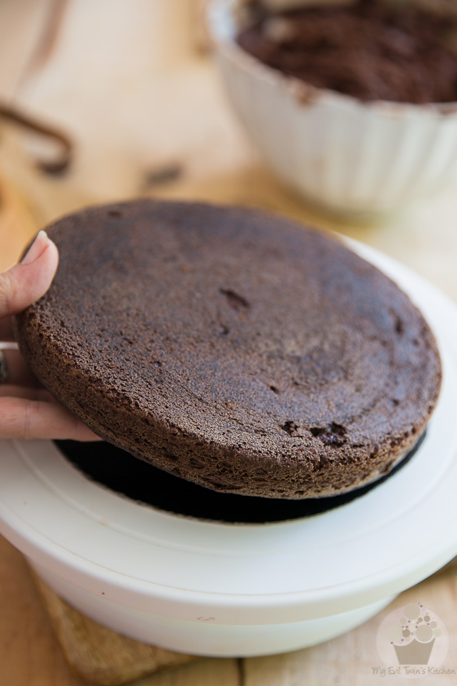 Place the cake on a round cardboard - part of My Evil Twin's Kitchen's Wicked Windmill Chocolate Cake step-by-step instructions