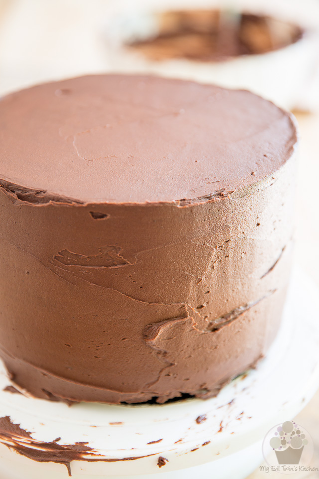 Cover the entire cake in frosting - part of My Evil Twin's Kitchen's Wicked Windmill Chocolate Cake step-by-step instructions