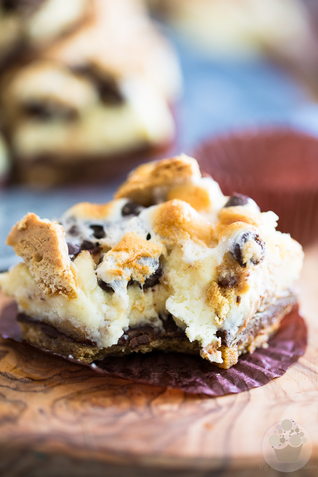 S'mores Cheesecake Bars, it's all the deliciousness of a classic Smores and the dreaminess of a creamy cheesecake rolled into one truly decadent treat! 