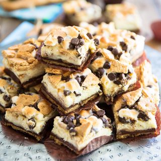 S'mores Cheesecake Bars, it's all the deliciousness of a classic Smores and the dreaminess of a creamy cheesecake rolled into one truly decadent treat!