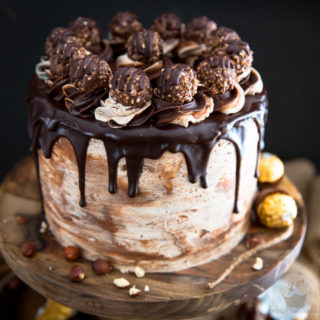 As spectacular as it may look, this Nutella Ferrero Rocher Chocolate Cake isn't nearly as complicated to make as you may imagine... but it certainly won't fail to impress, and please, the chocolate lovers in your life!
